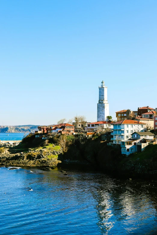 an island on the river with a white lighthouse in the middle