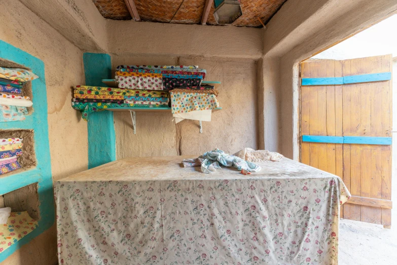 a small hut is decorated with different fabrics