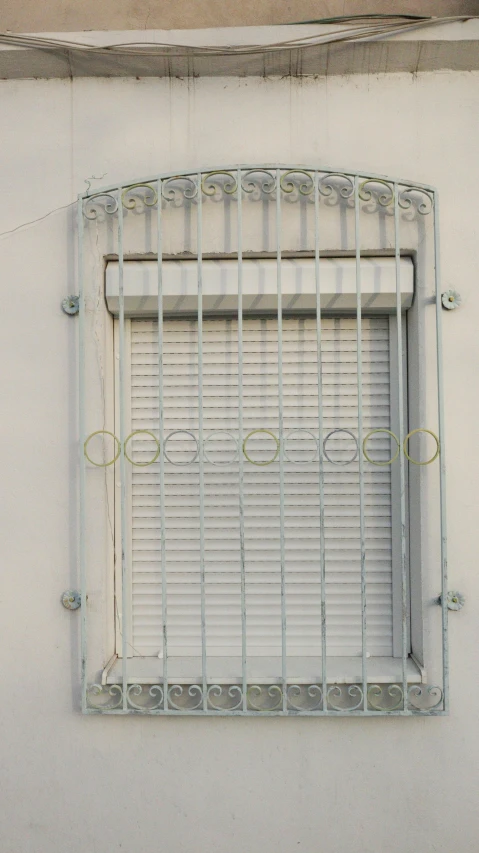 a small window in a white wall with green circles