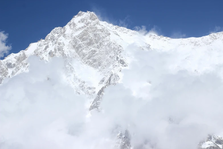 a view of the top of a mountain with clouds