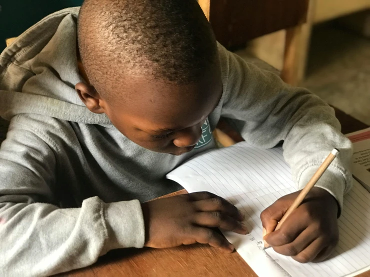 a boy doing a hand written exam on a piece of paper