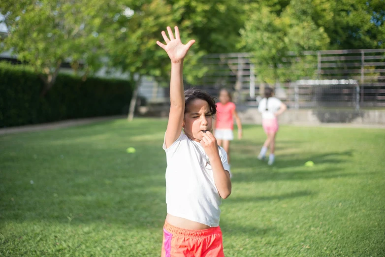 three little girls who are playing outside