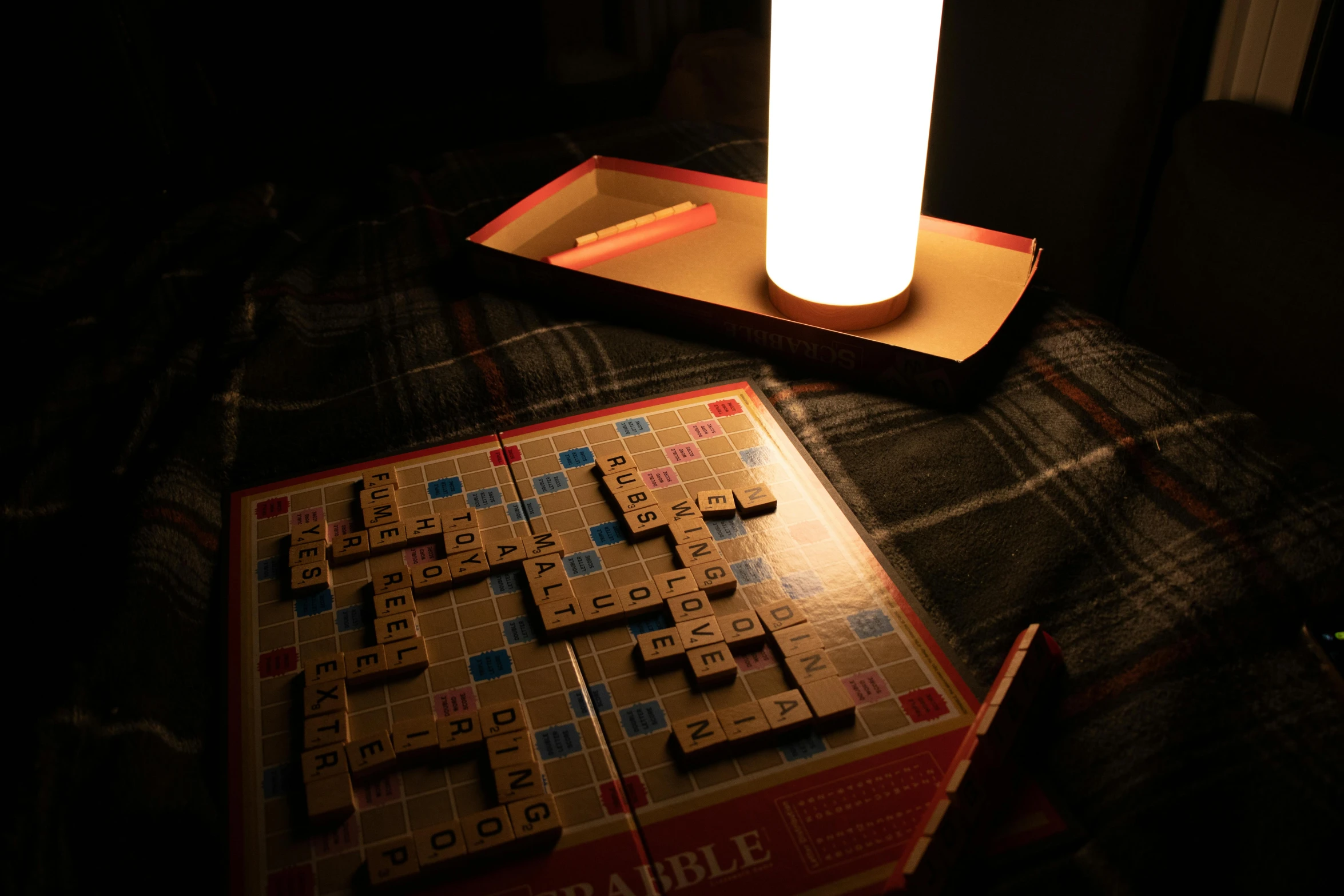 a box with a lighted scrabble next to it