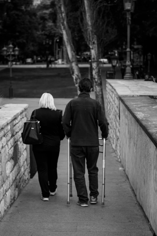 black and white pograph of an elderly couple walking together