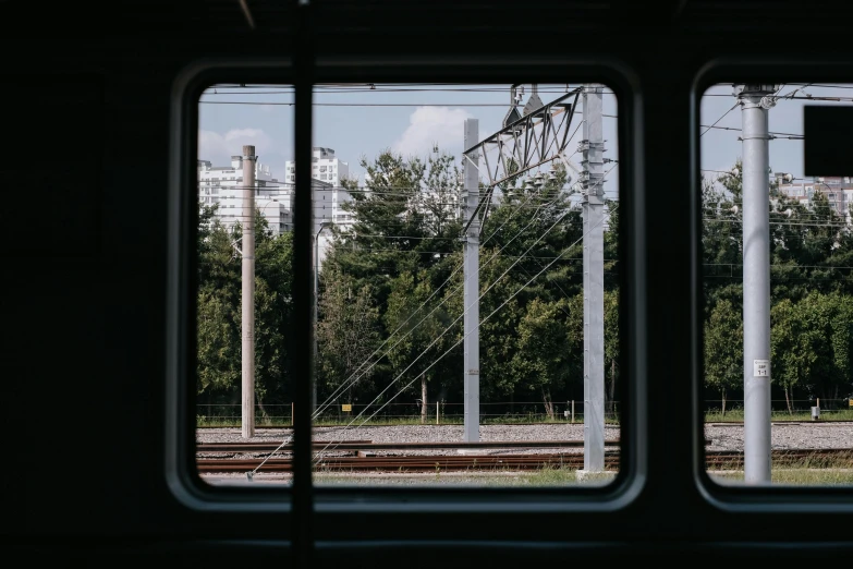 a window with trees outside and power lines