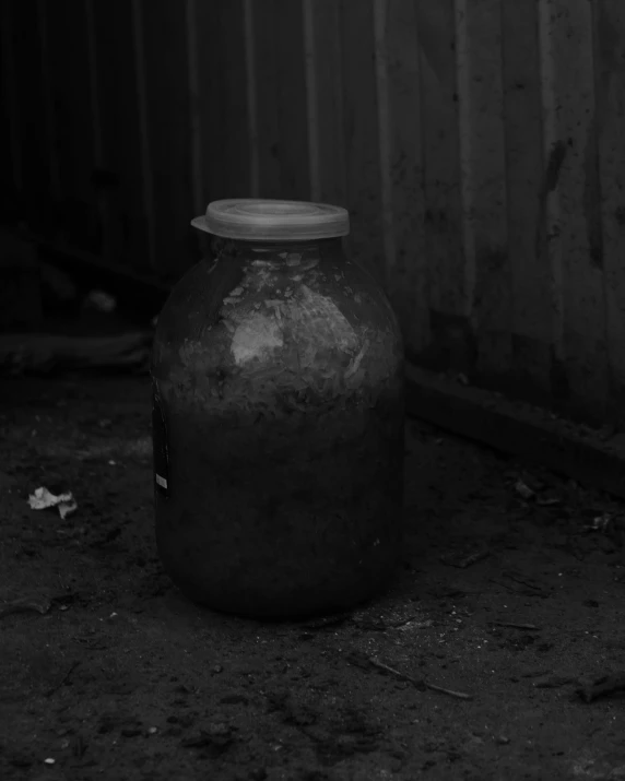 an old, empty container sitting in the corner of a yard