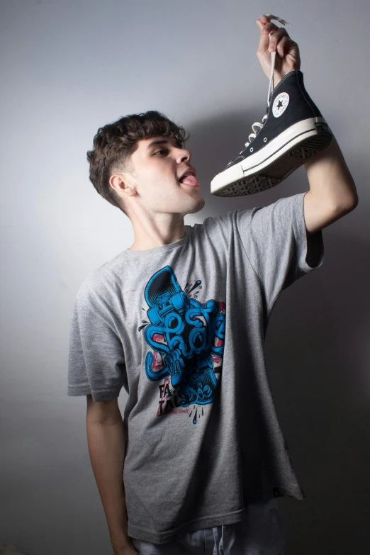 a person in a grey shirt and some sneakers