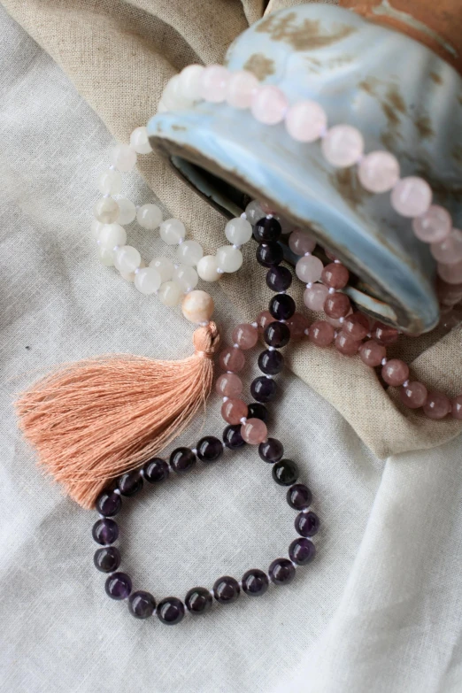 the beads on a table have tassels of ayst colors