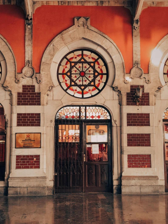 an entrance to a building with many stained glass windows