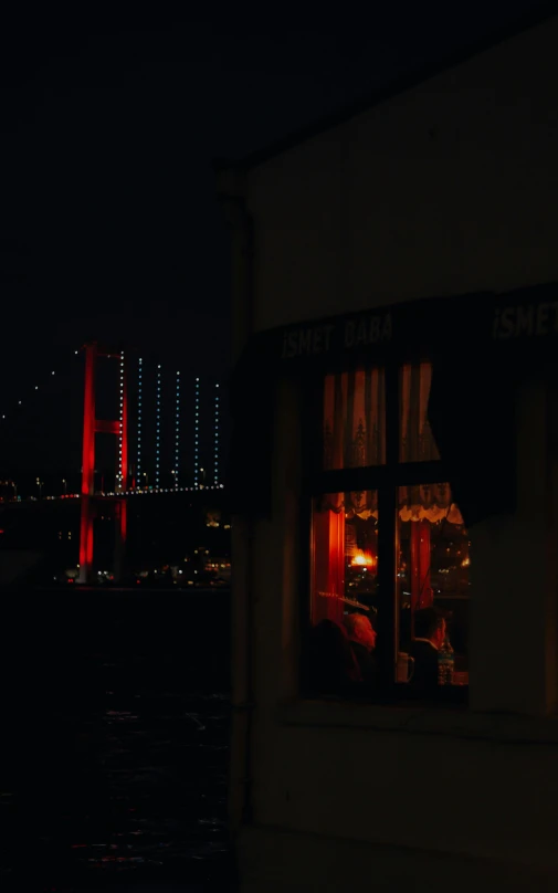 a building that has a view of the bay and red and blue bridge