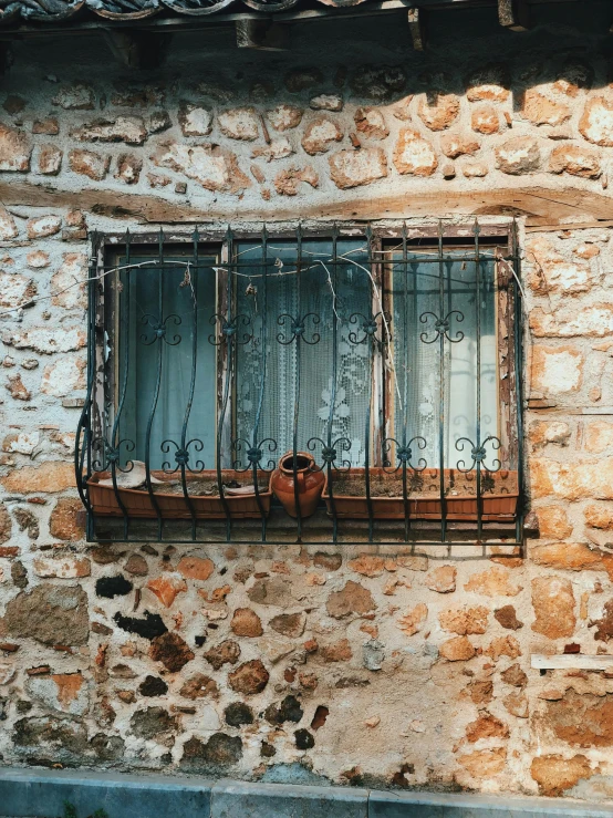 a brick wall with a window and wire attached to the outside