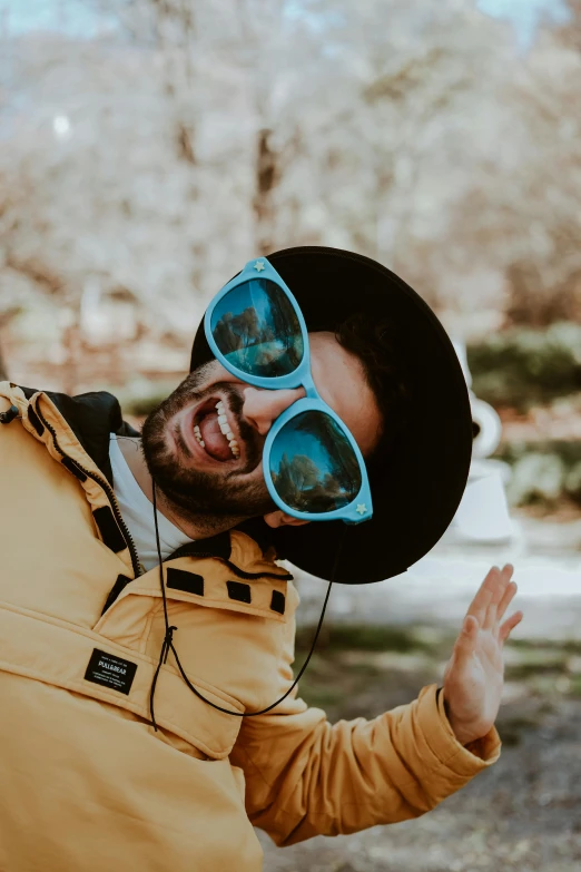 a man with sun glasses making a face