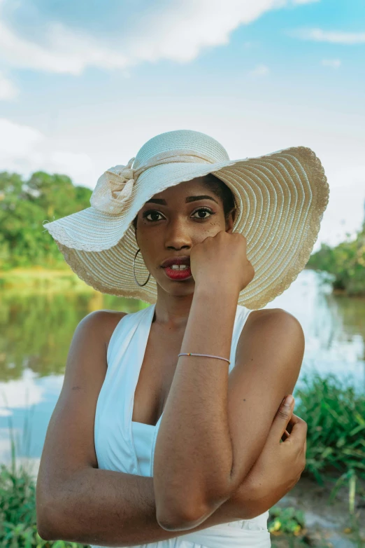 an image of a woman posing for the camera wearing a hat