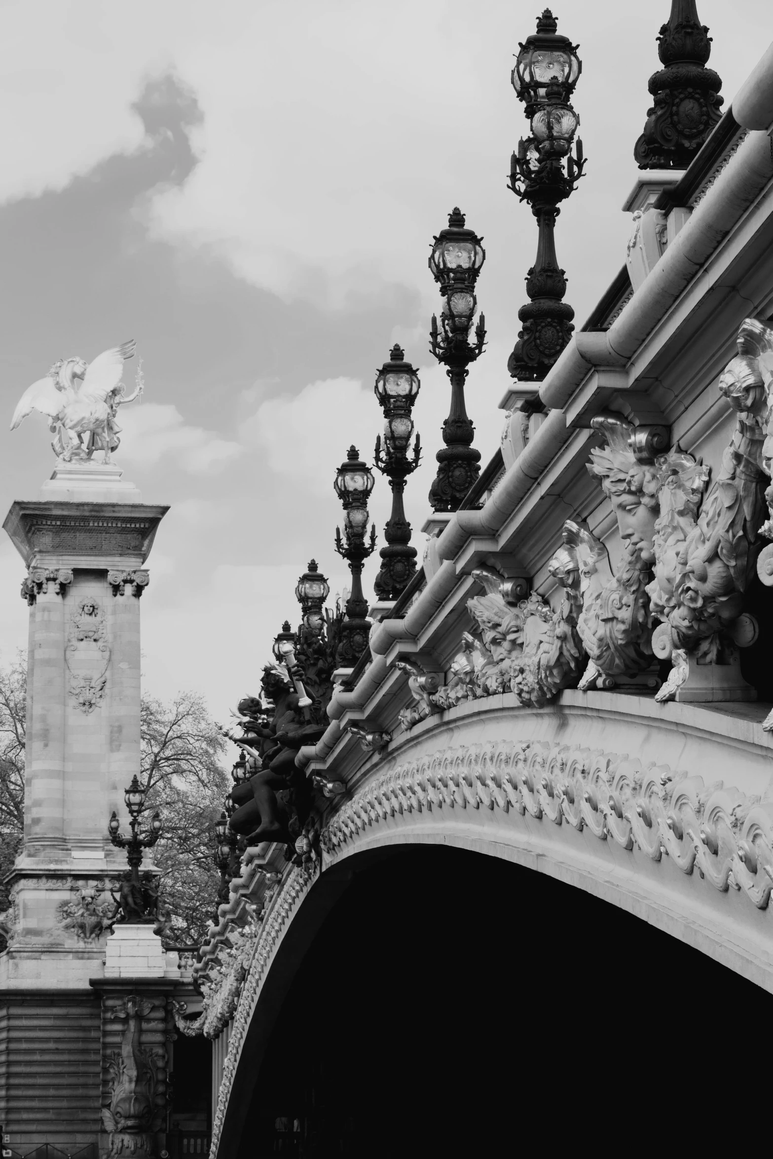black and white pograph of ornate details surrounding an archway