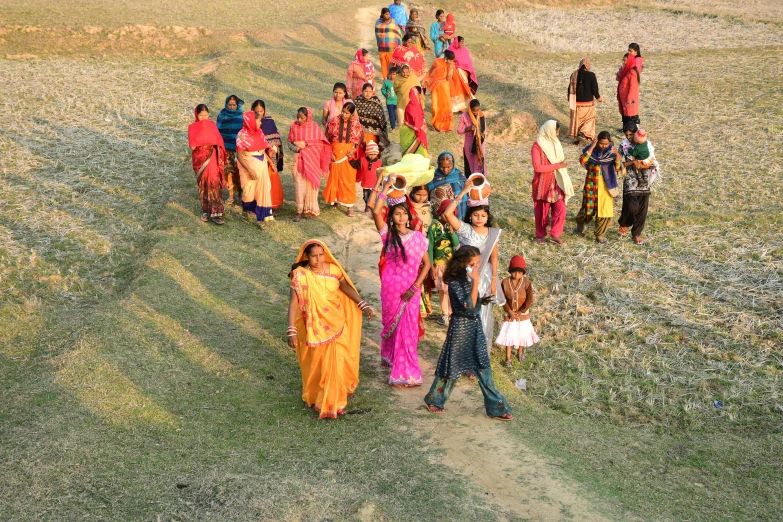 the group of women are walking in this field