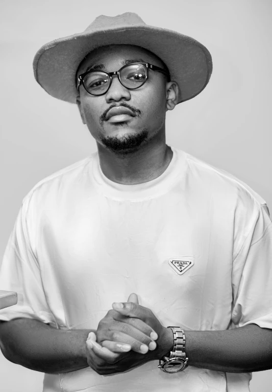 a young black man wearing glasses and a hat