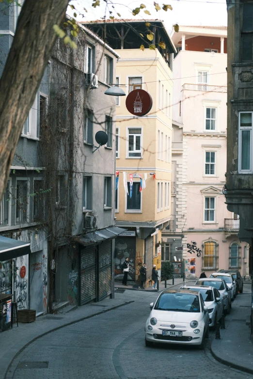 this is a city street with cars and buildings