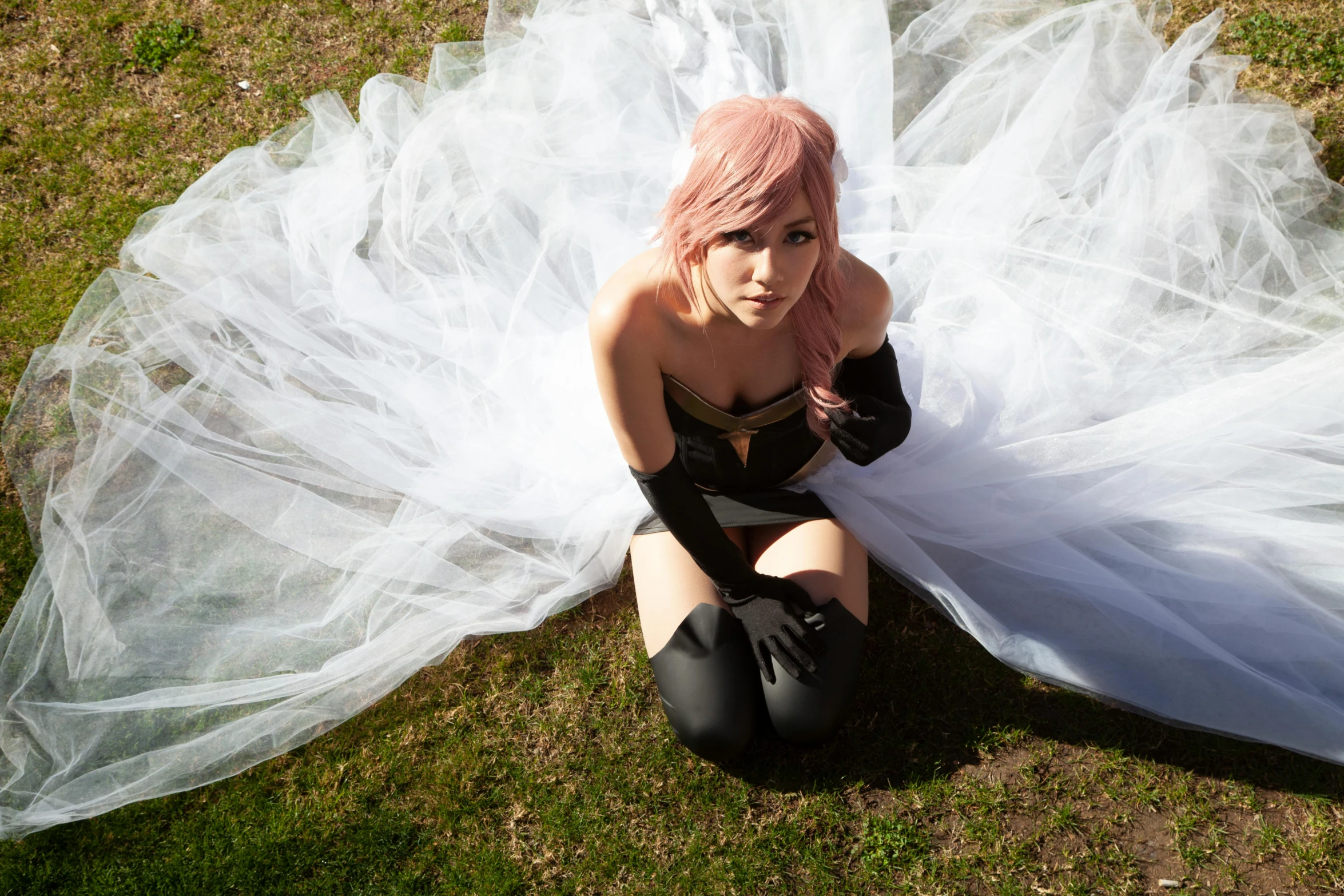 a woman with pink hair sitting on the ground