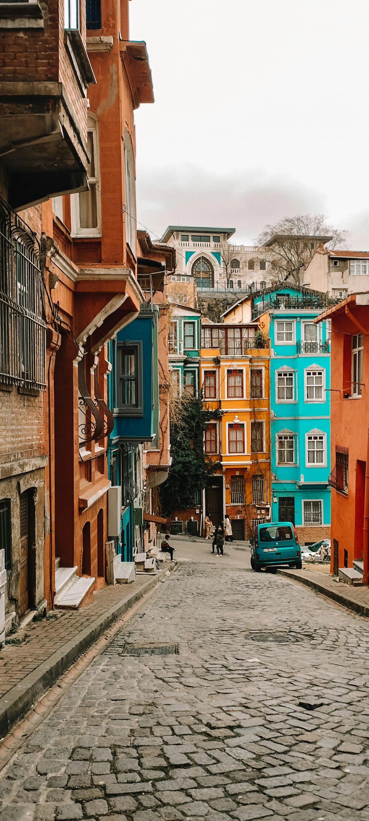 a view of an old city street from the cobblestone pavement