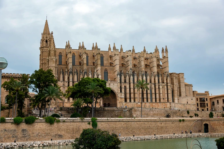 a castle like building is sitting next to the water