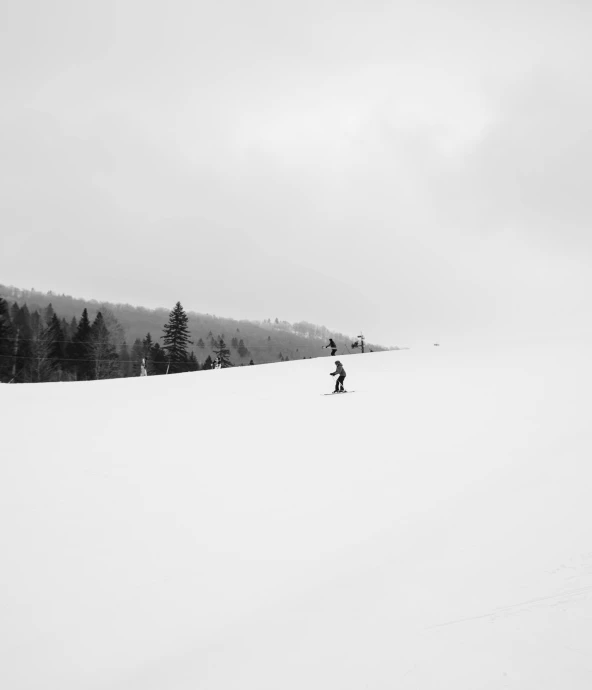 someone is walking through the snow in the distance