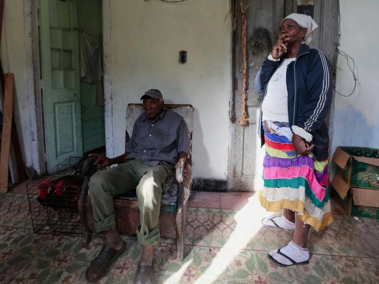 two men sitting on their seats in the sunlight