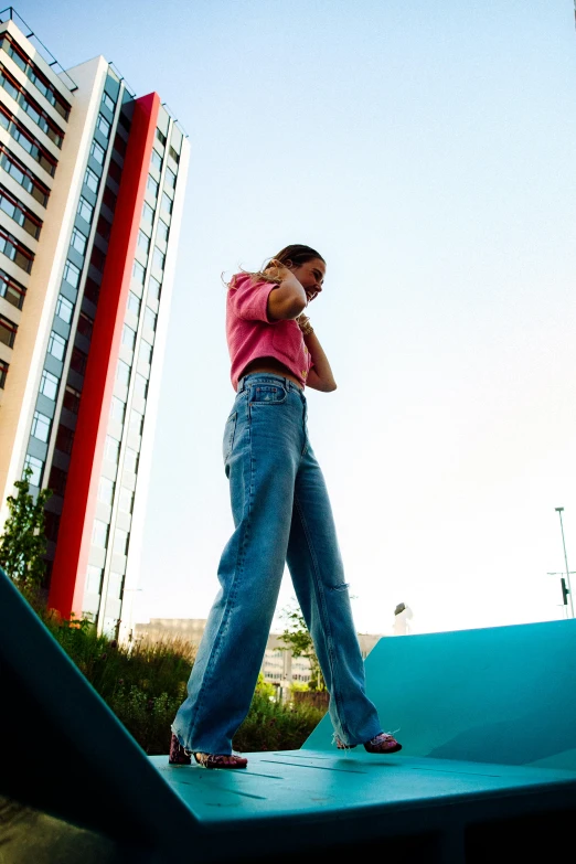 a young man talks on his cellphone as he walks up a ramp