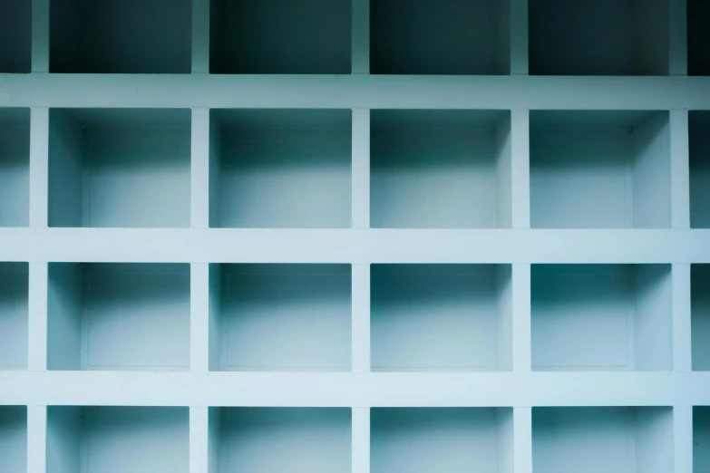 an open shelf with several empty shelves in the wall