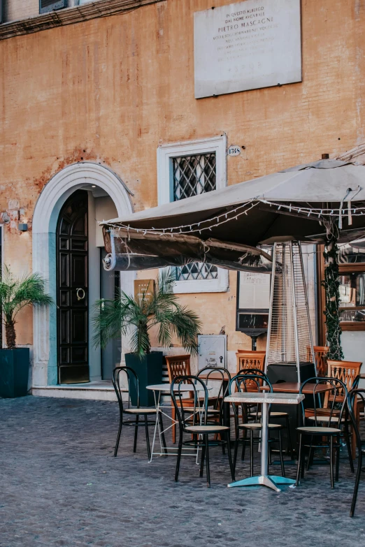 the courtyard has outdoor tables, chairs, umbrellas and plants