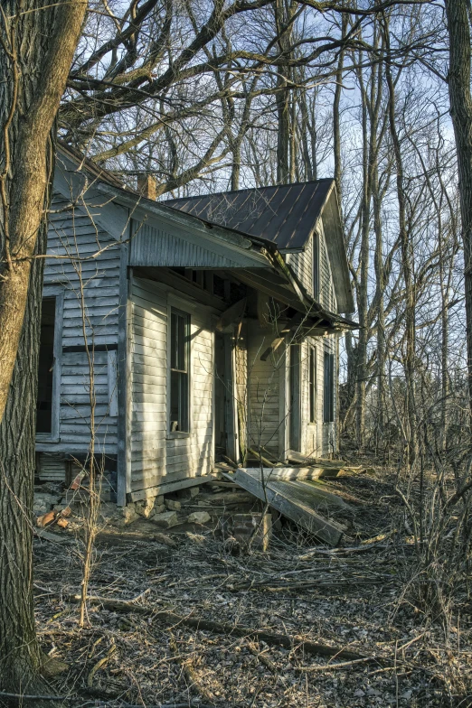 an abandoned house sitting in the woods