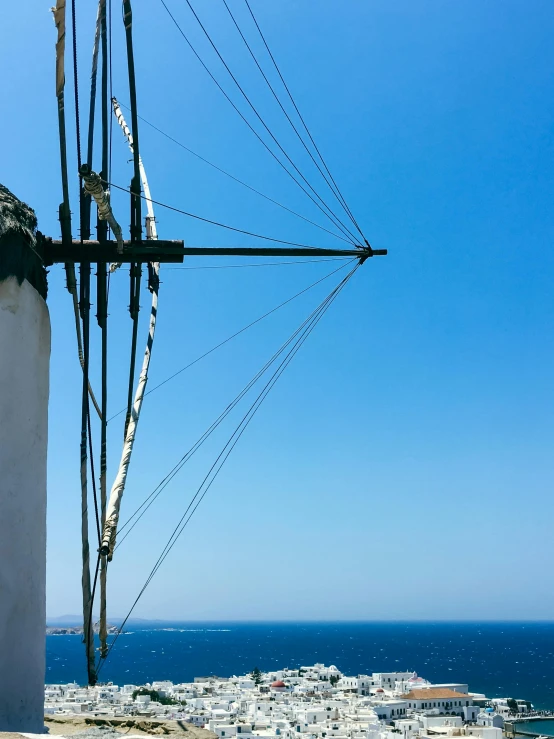 an old power line with the ocean in the background