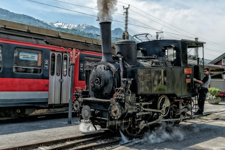 an old fashioned steam train with smoke coming out