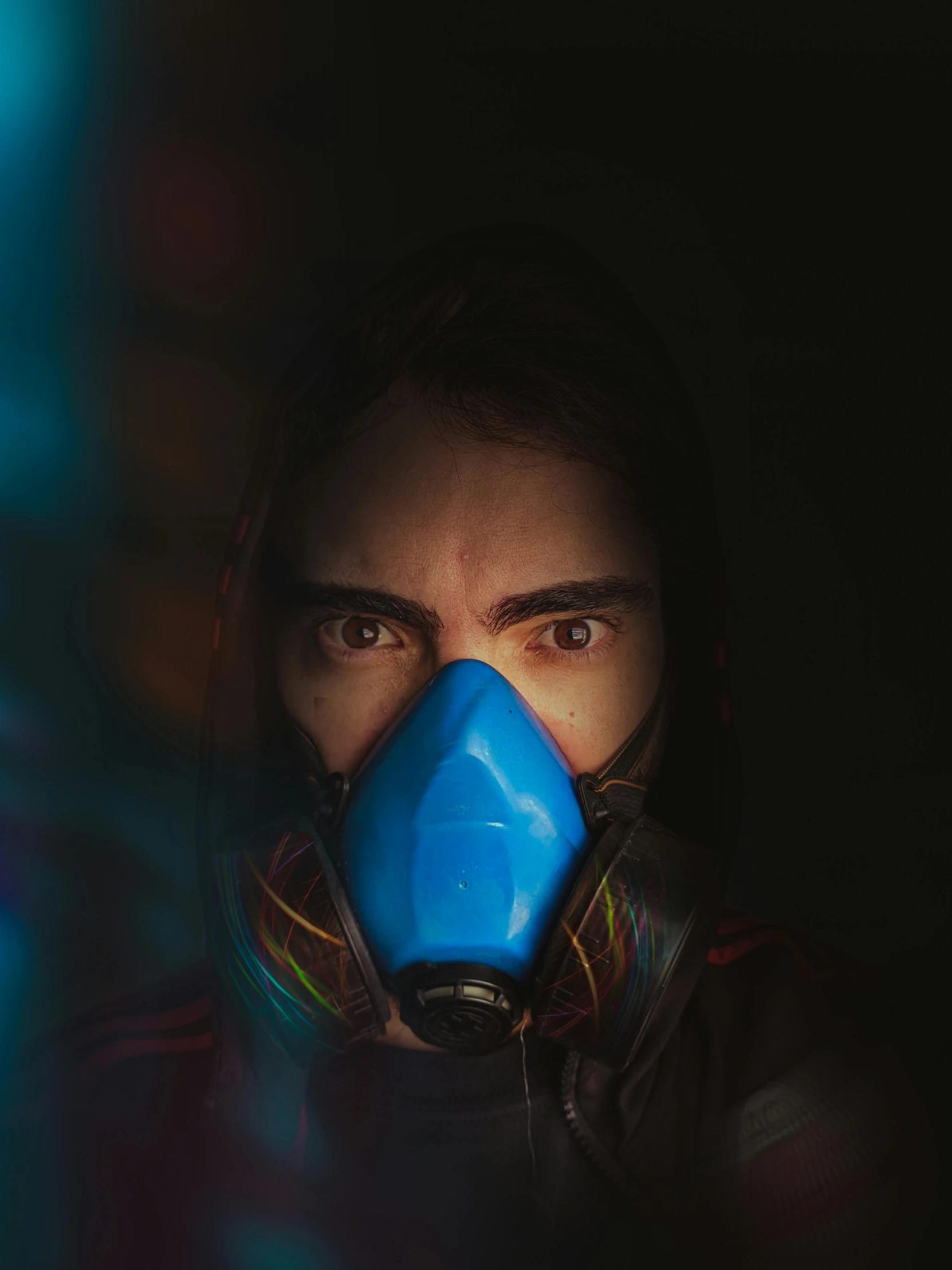 a man wearing a gas mask in the dark