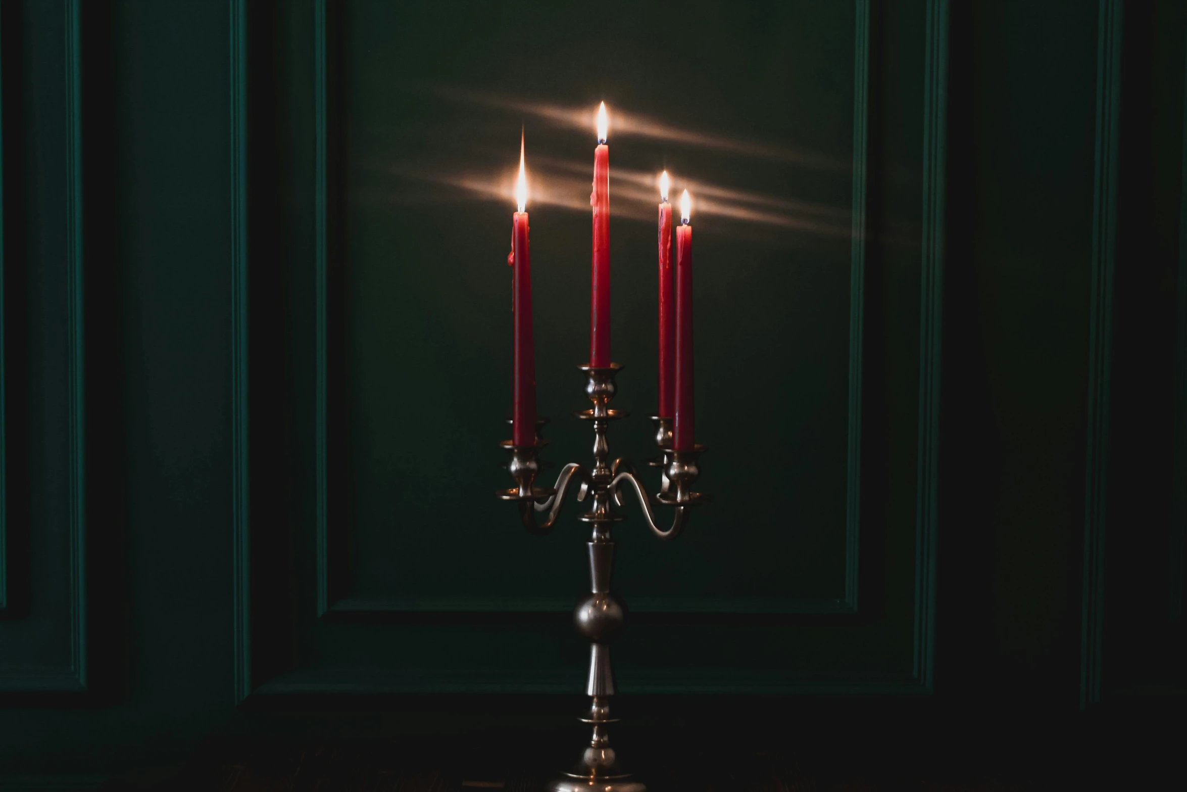 a double candle holder with lit candles on the top