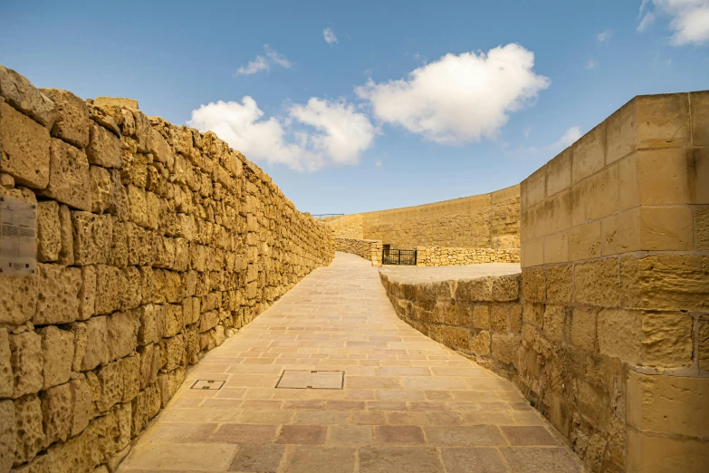 a pathway going through a stone wall in a stone town