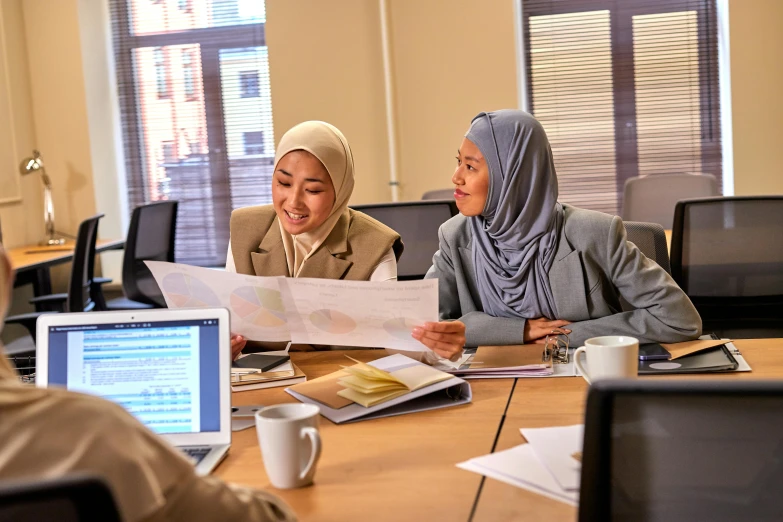 two woman are in the middle of a business meeting