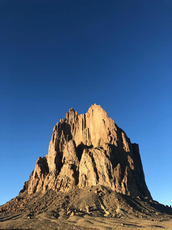 a large mountain stands tall in the desert