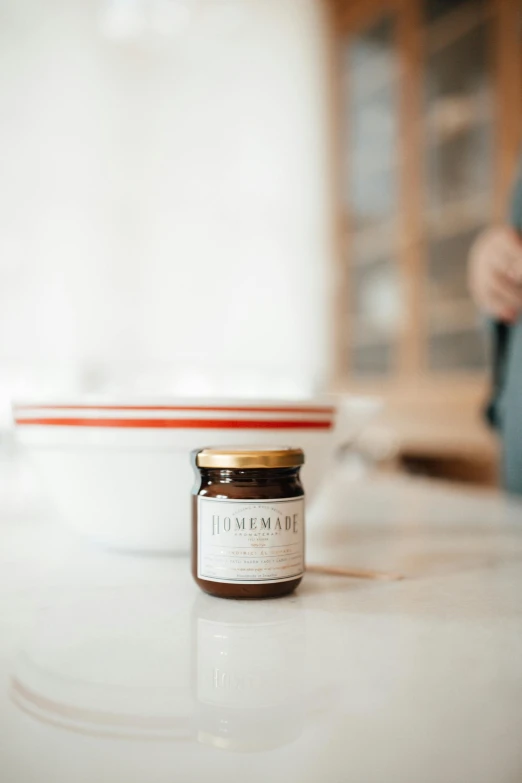 a glass jar with a candle on the top