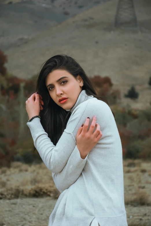 young woman in the desert looking bored