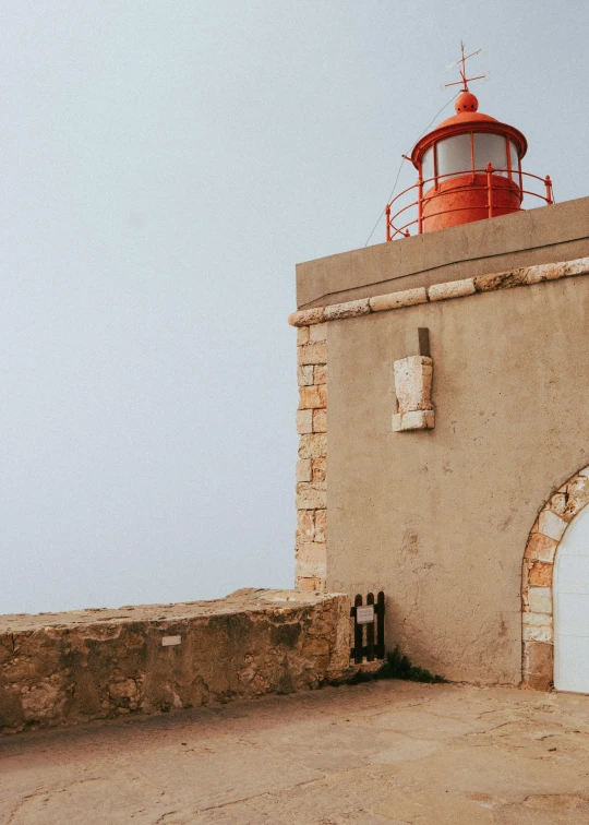 a light house that is on a rocky beach