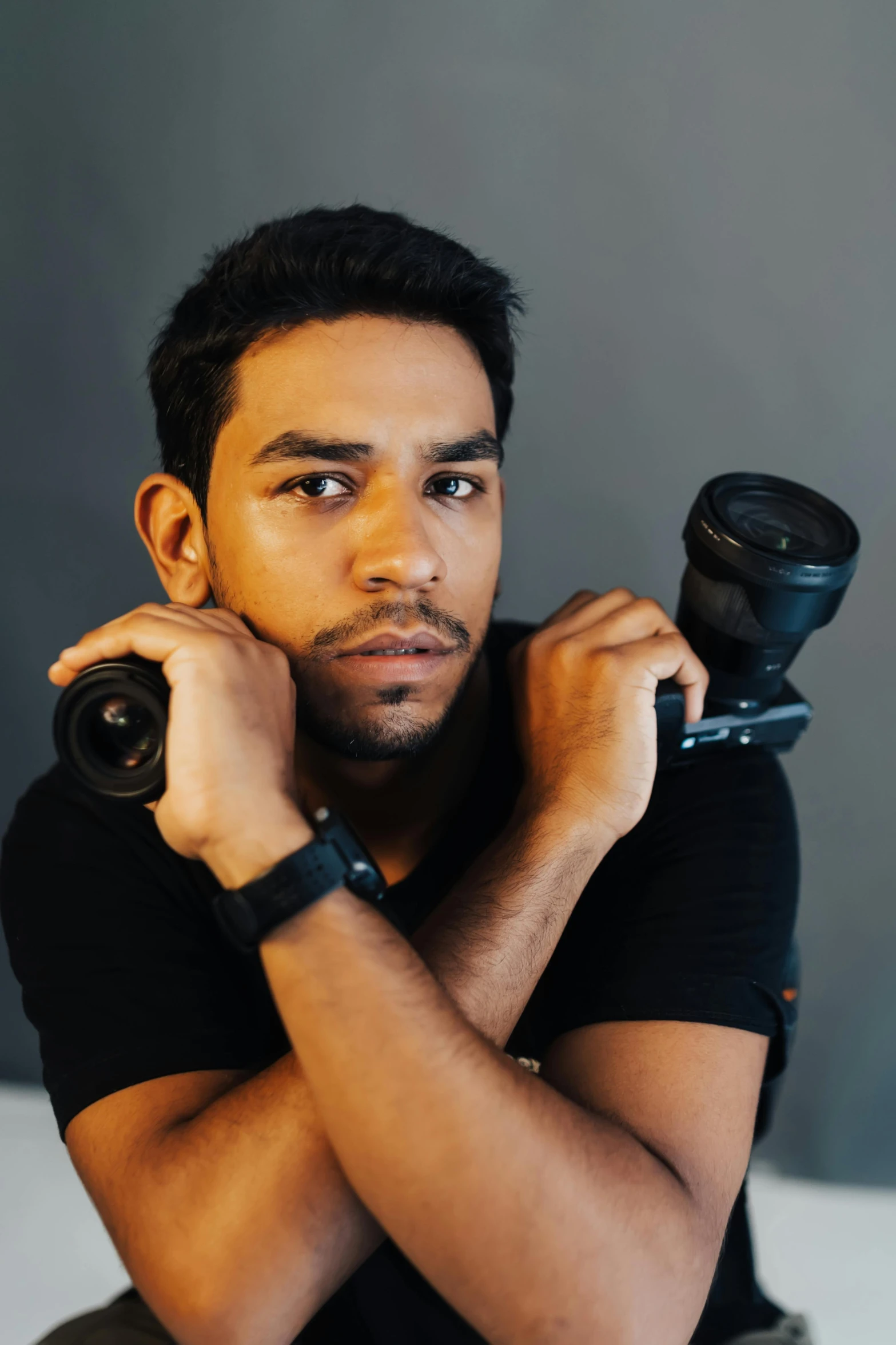 a man holding a camera looking into the camera