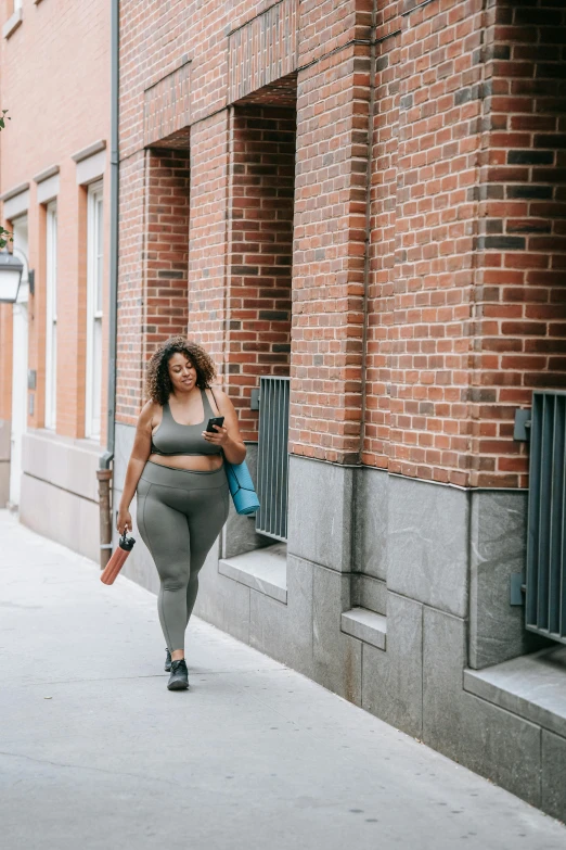 a woman in tights walking down the street