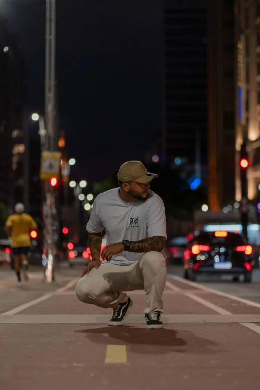 a man kneeling down next to a street