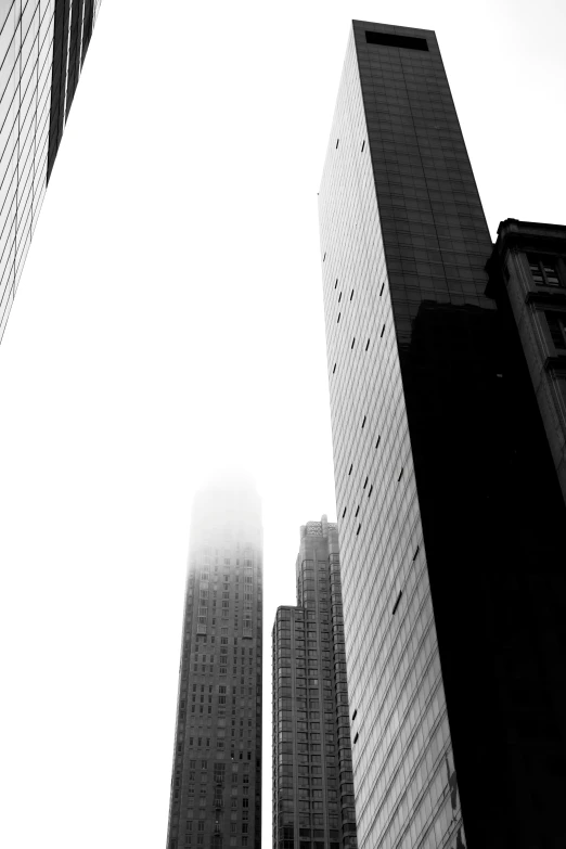 two tall buildings towering over the skyline of city