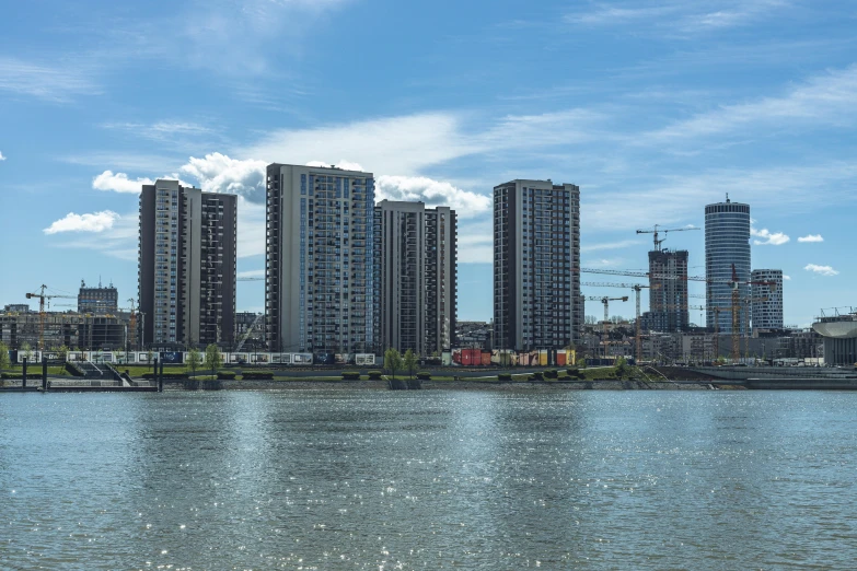 tall buildings sit along a body of water