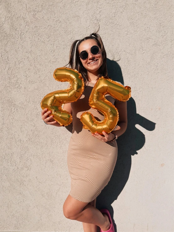 a woman in a skirt holding balloons and posing