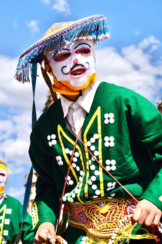 two men with face paint on each side and hats on