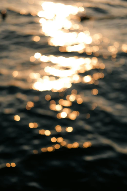 a blurry image of the sun on the ocean