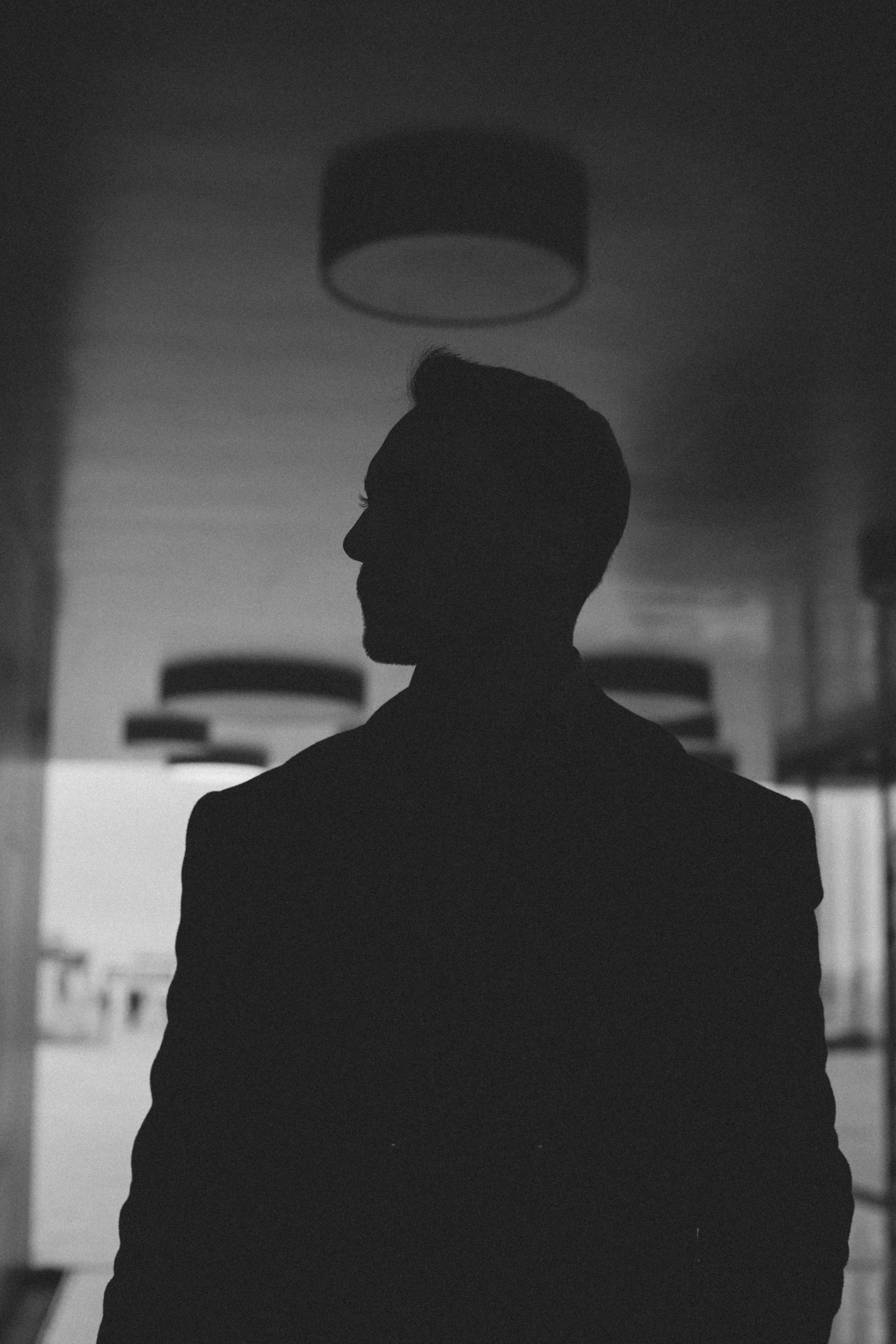 silhouette of a man standing in an office