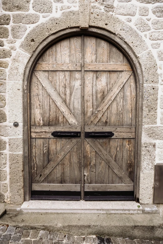 an old and run down door with brick arches